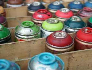 A box of used aerosol cans