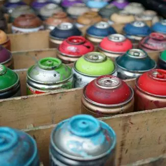 A box of used aerosol cans