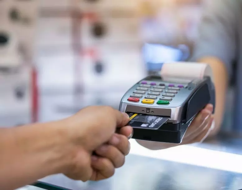 A person uses a credit card payment machine